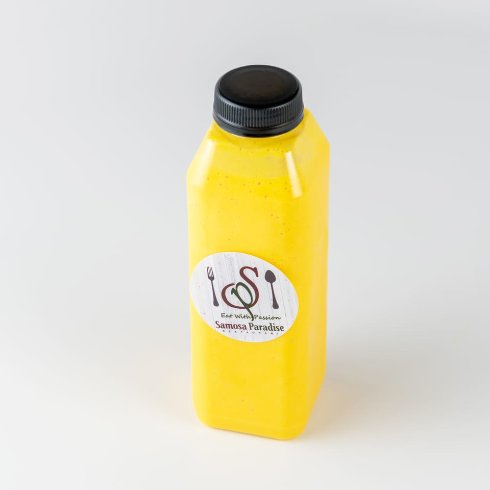 Yellow bottled beverage labeled Samosa Paradise Restaurant, standing against a plain white background.